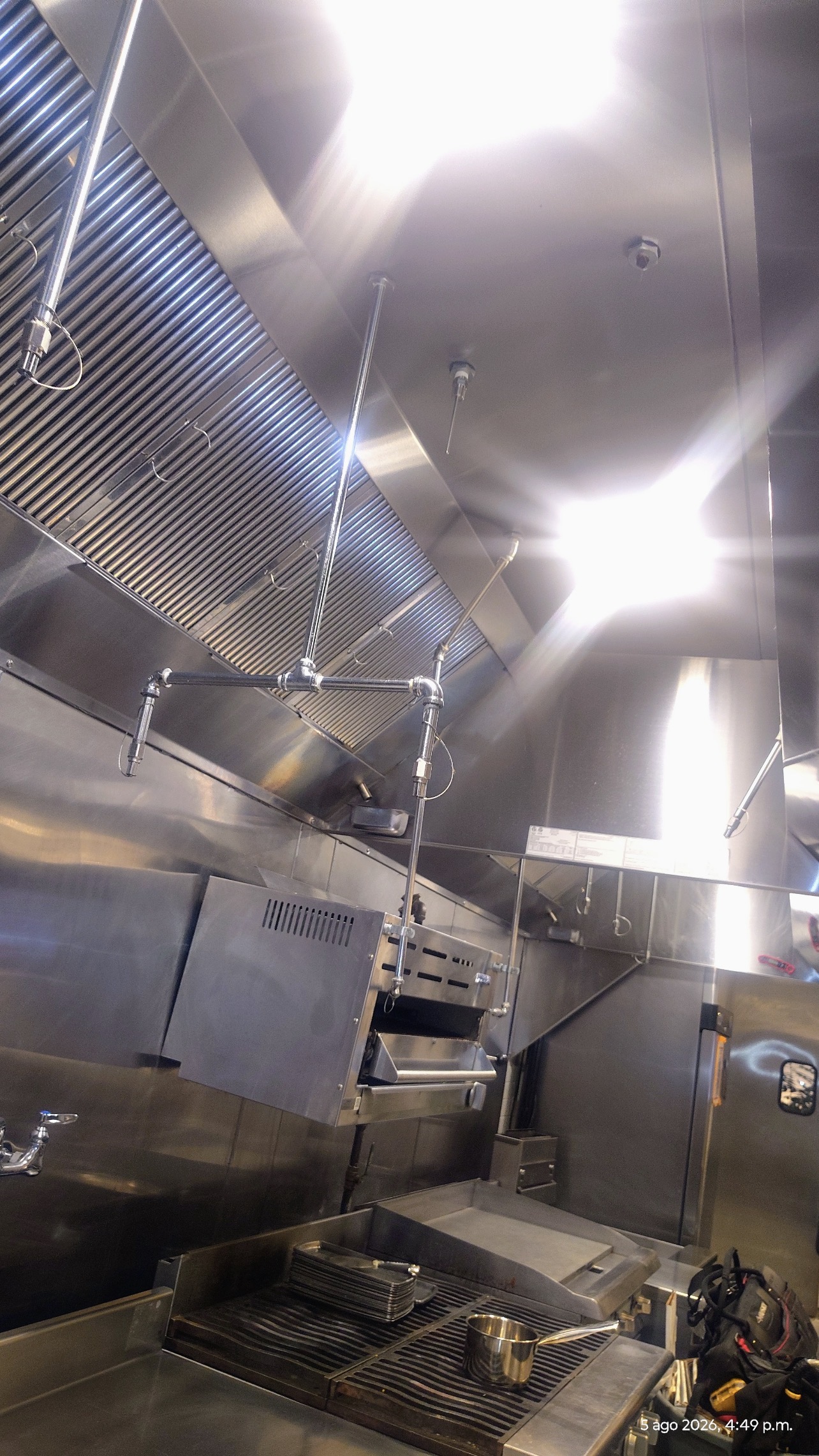 Clean commercial kitchen hood and fire suppression piping